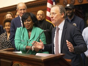 Philadelphia 76ers owner Josh Harris speaks during a news conference as Philadelphia Mayor Cherelle Parker, left, listens, Monday, Jan. 13, 2025, at City Hall, in Philadelphia, after the NBA basketball team abandoned a plan to build a new arena in Center City.