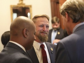 South Carolina Rep. Branon Guffey speaks to senators outside the House chamber in Columbia, South Carolina, Wednesday, May 2, 2023. Guffey's 17-year-old son took his own life in July 2022 after a Nigerian man posed as a woman and then tried to extort the teen after he sent nude photos.