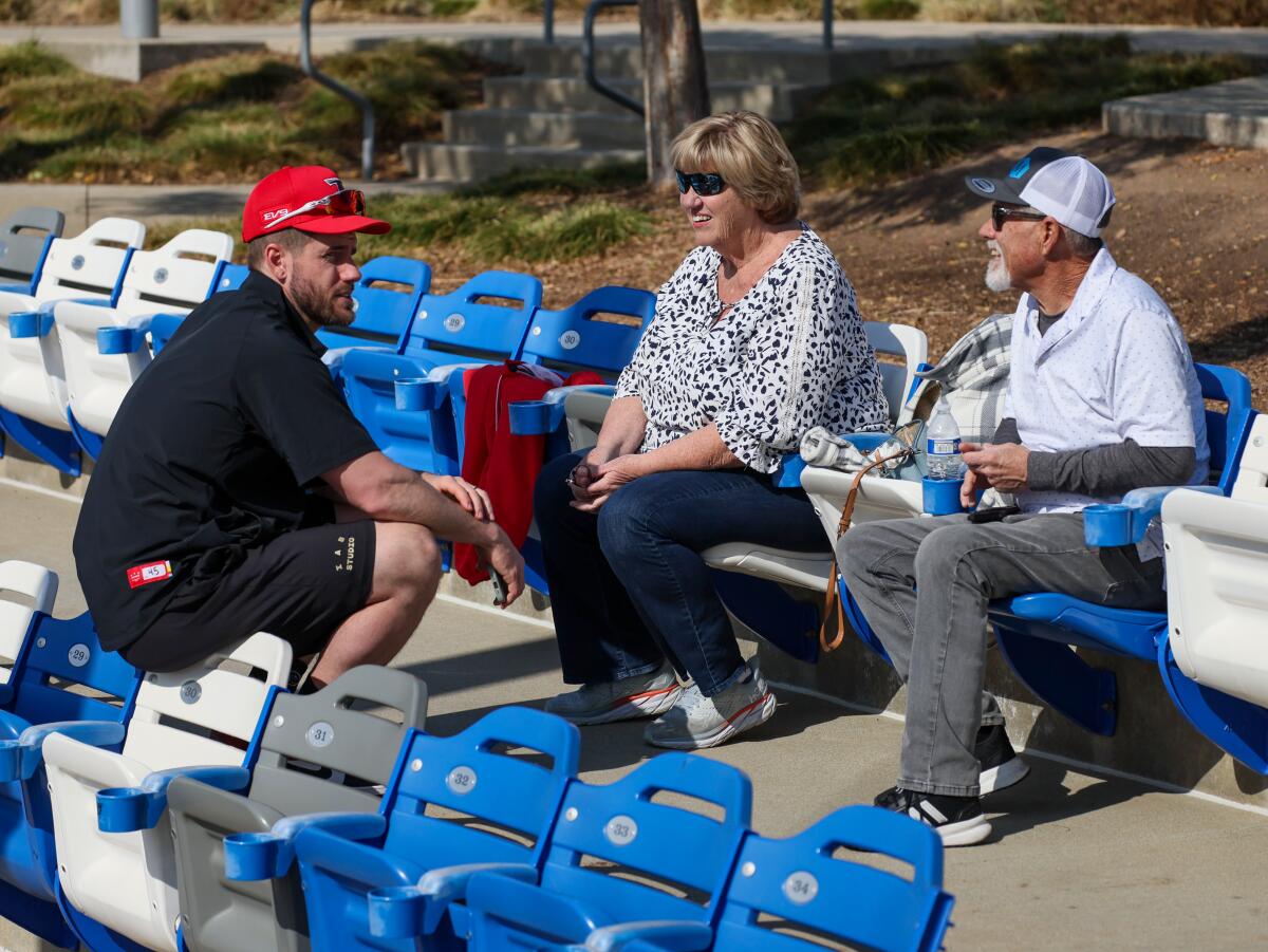 Former Cubs infielder Patrick Wisdom chats with his parents, Pat and Colleen Wisdom after working out with the Kia Tigers.