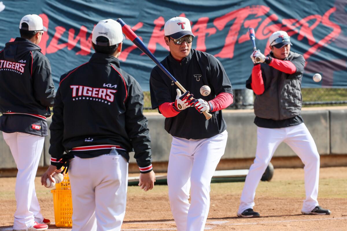 The Kia Tigers, a Korean Baseball Organization team, conducts spring training in Irvine. Coaches hit balls for infield drills