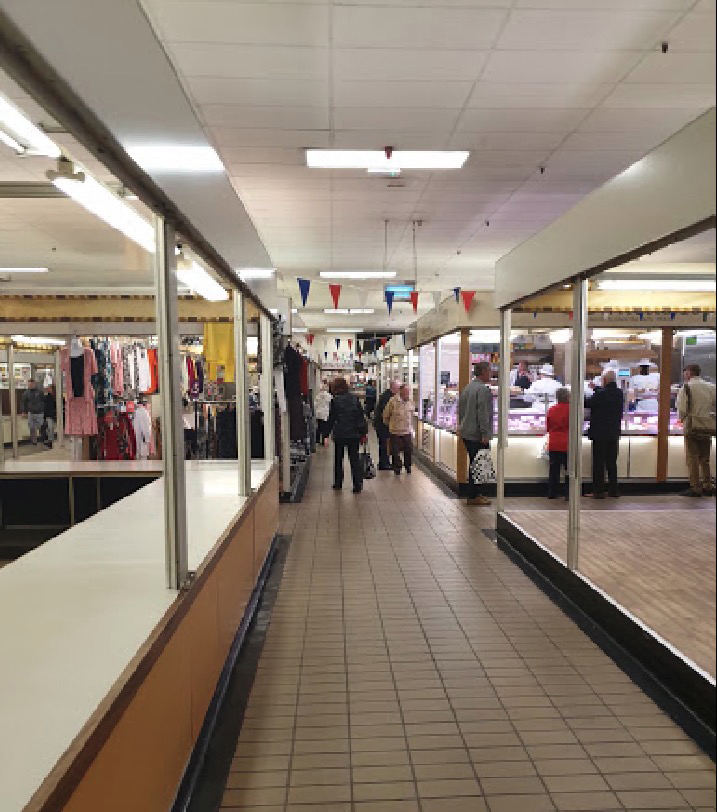 Interior view of a market nearing closing time.