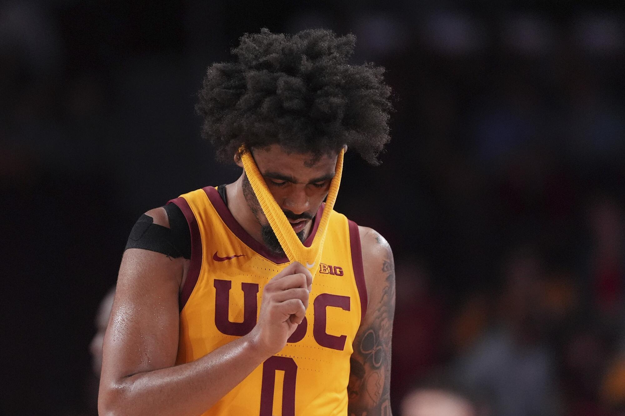 USC forward Saint Thomas takes off his headband after a loss to Wisconsin on Jan. 18.