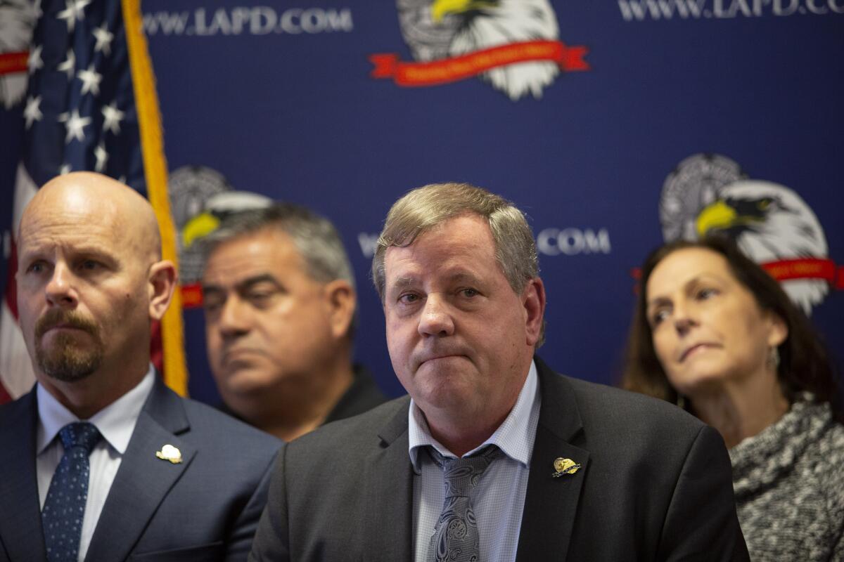 Craig Lally, center, President of the Los Angeles Police Protective League, speaks during a news conference