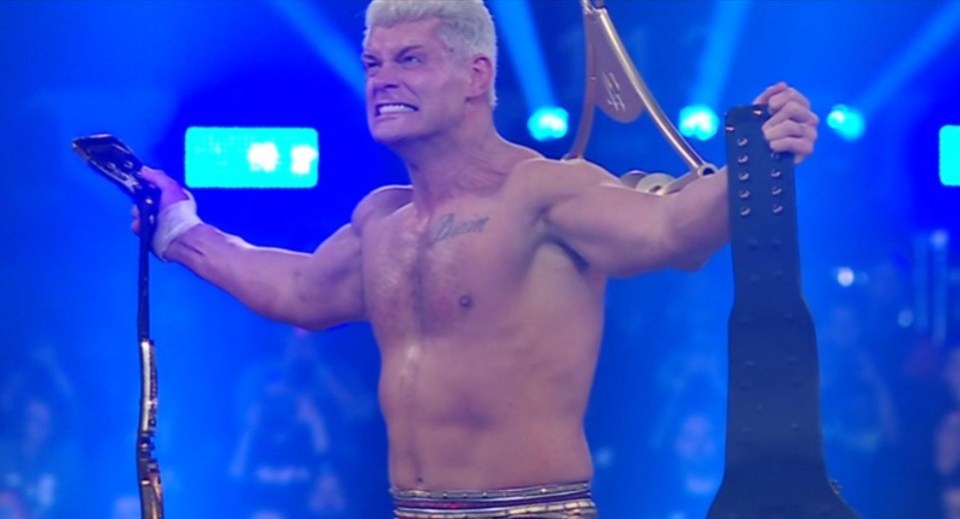 Cody Rhodes holding a championship belt.