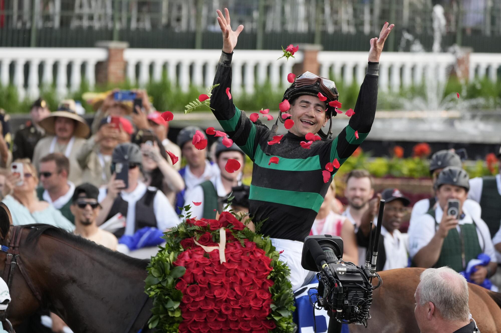 Jockey Brian Hernandez Jr. celebrates in the winner's circle after riding Mystik Dan to win the 2024 the Kentucky Derby 