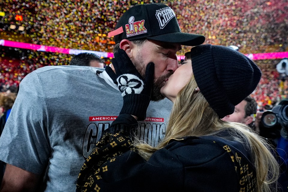 Travis Kelce and Taylor Swift kissing after a football game.