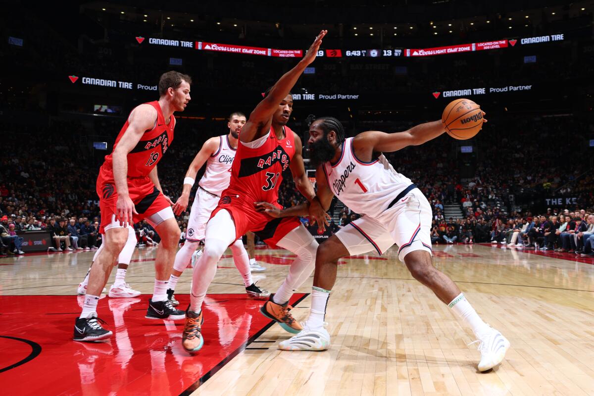 Clippers guard James Harden has his drive into the lane cut off by Raptors guard Ochai Agbaji.