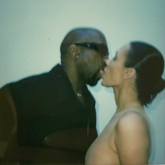 Kanye West and Bianca Censori kissing.