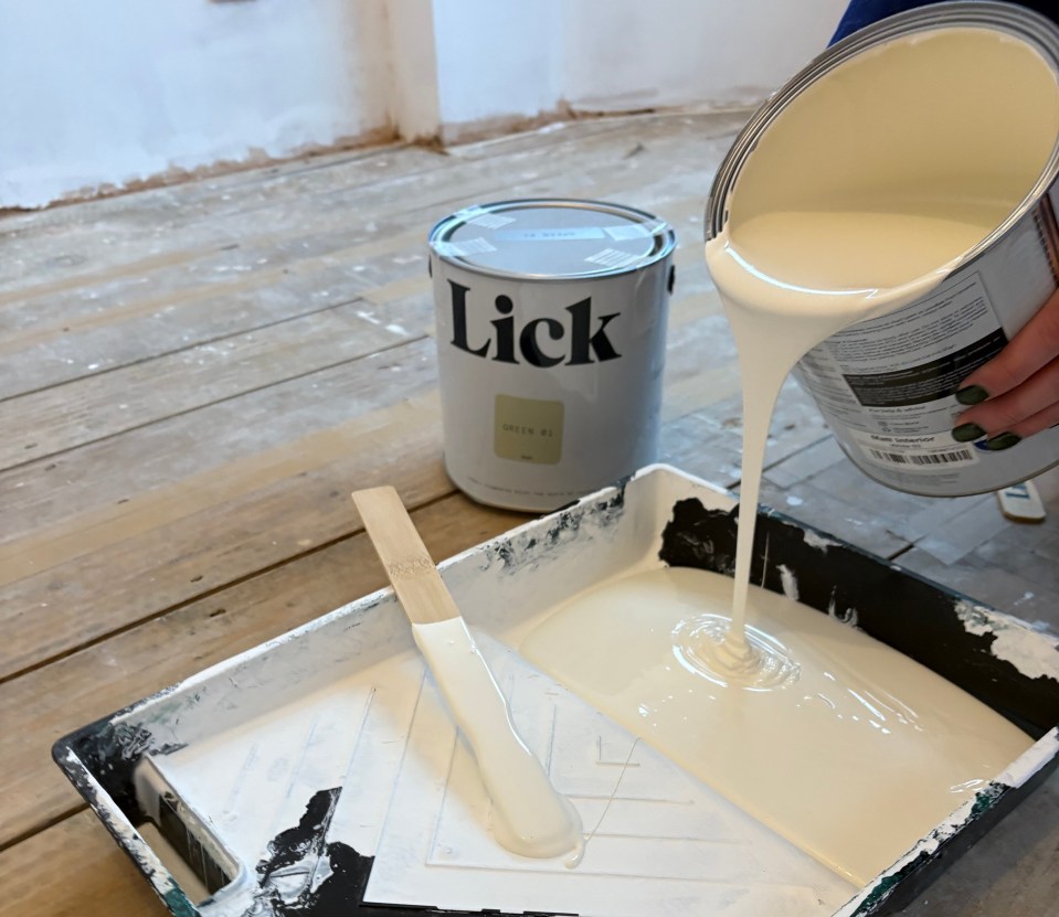 White Lick paint being poured from a can into a paint tray.