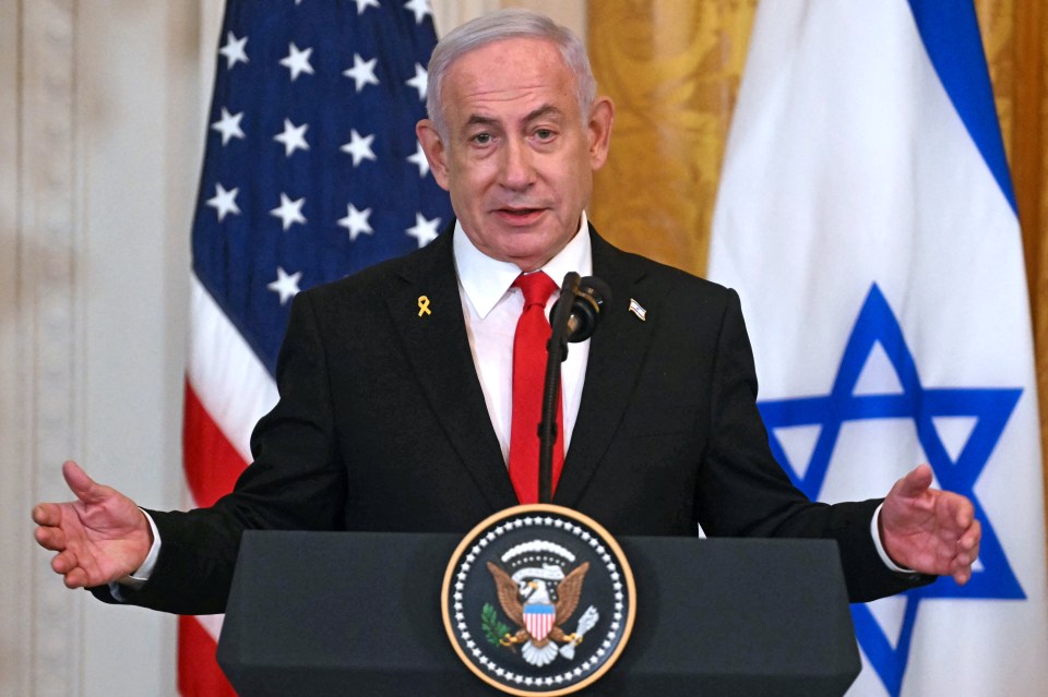 Benjamin Netanyahu speaking at a podium with US and Israeli flags in the background.