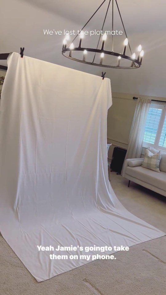 Behind-the-scenes photo of a makeshift baby photoshoot setup.