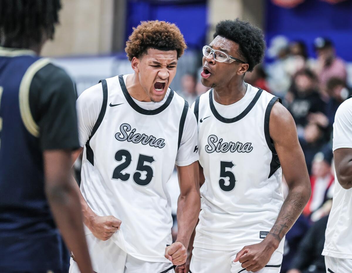 Maximo Adams (left) gets fired up after basket and receives encouragement from Sierra Canyon teammate Bryce James.