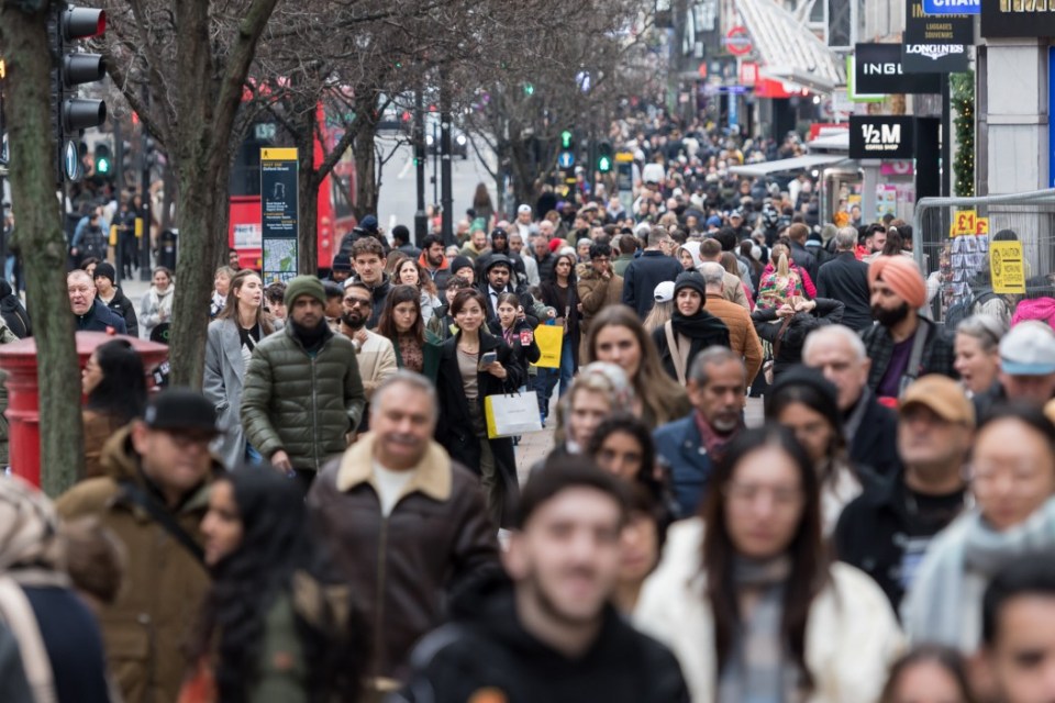 LONDON, UNITED KINGDOM - DECEMBER 26: Shoppers walk in Oxford Street during Boxing Day sales in London, United Kingdom on December 26, 2024. The second day of Christmas holidays, Boxing Day sees retailers offer large discounts which attract customers who this year are predicted to spend £3.73billion on the day itself on the high street and online. (Photo by Wiktor Szymanowicz/Anadolu via Getty Images)