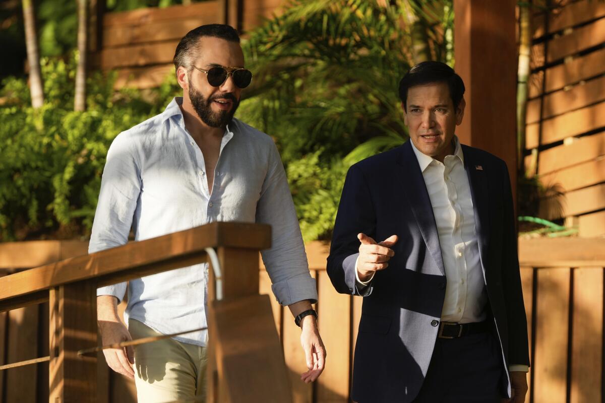 Secretary of State Marco Rubio, right, walks outdoors with El Salvador President Nayib Bukele 