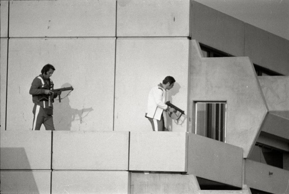 Black and white photo of two armed men on a rooftop during the 1972 Munich Olympics hostage crisis.