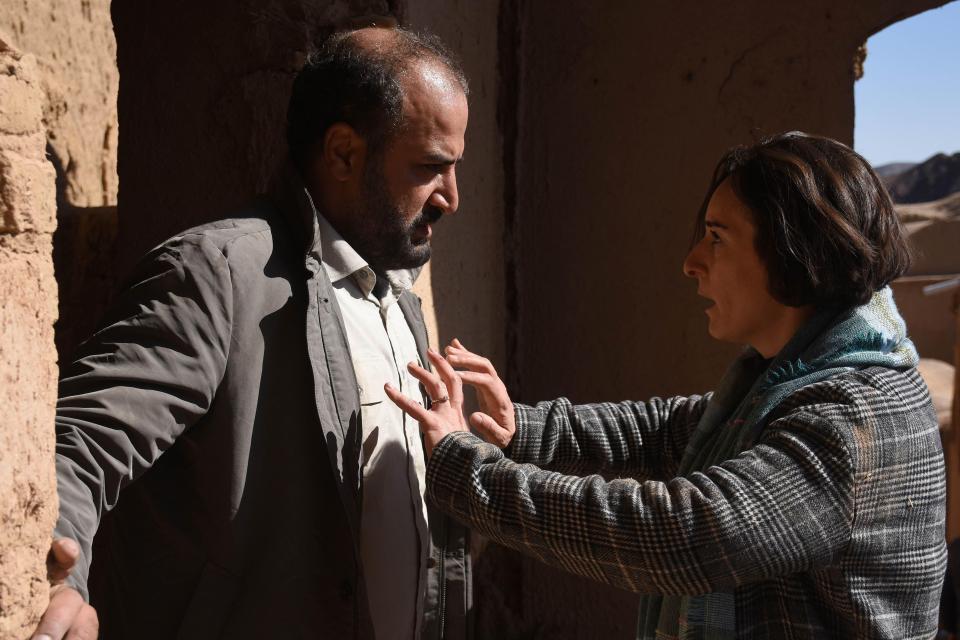 Still from the film *Les graines du figuier sauvage*, showing a man and woman in an intense conversation.