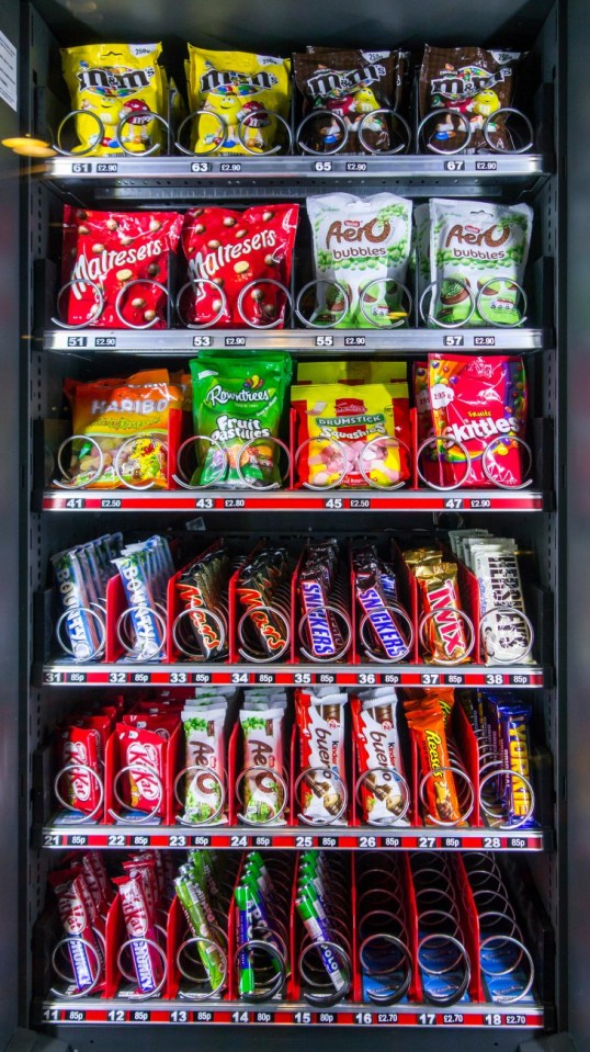 JR6PKG Snack vending machine / snack dispenser selling colourful sweets and chocolate bars in public place