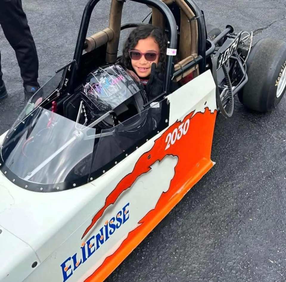 Girl in a race car.