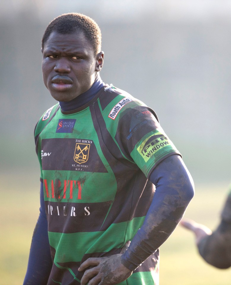 A rugby player in a muddy uniform.