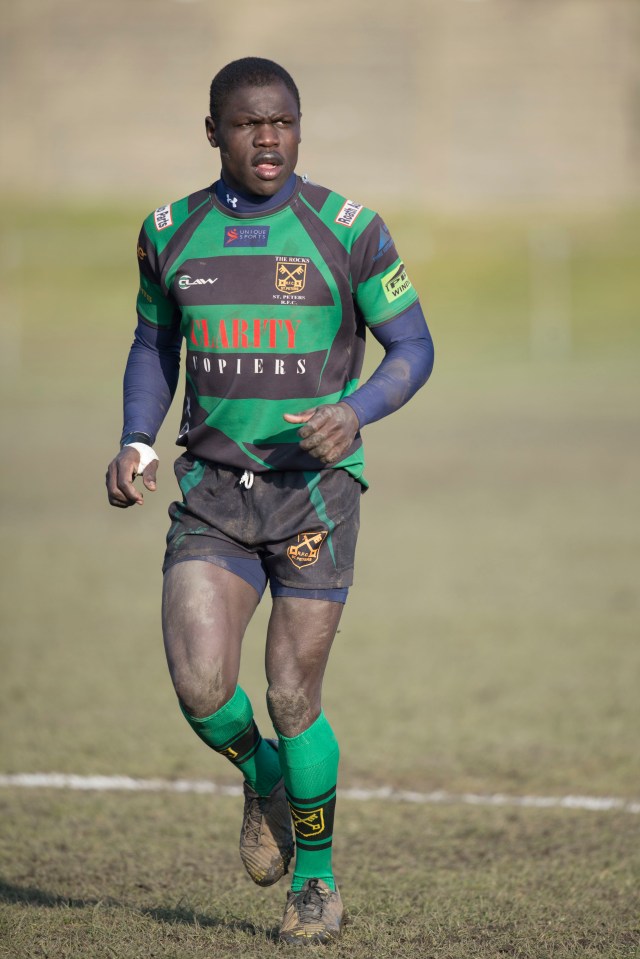 A rugby player in a green and black uniform.