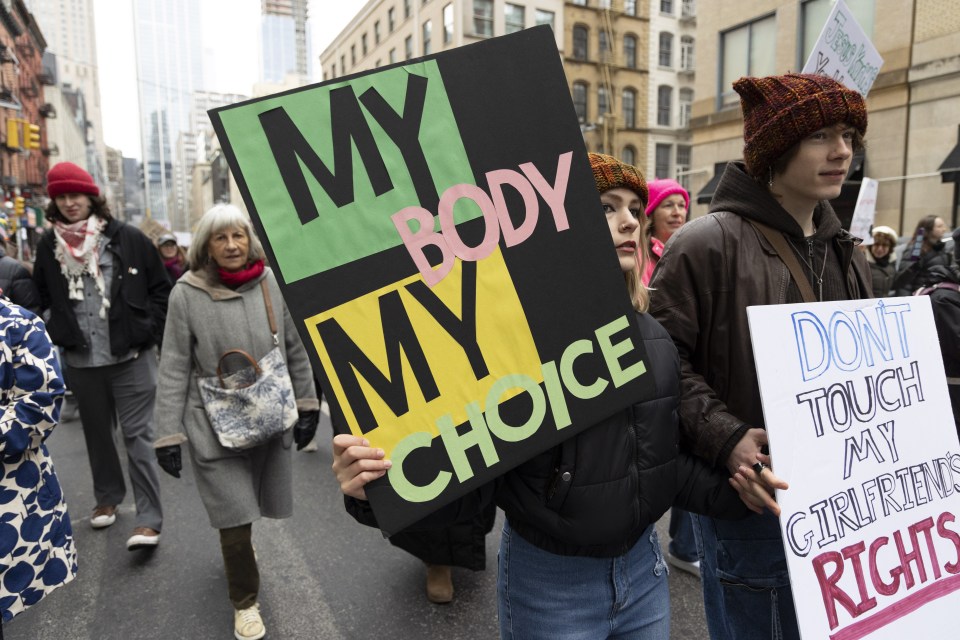 Protester holding a sign that reads "MY BODY MY CHOICE" at a march.