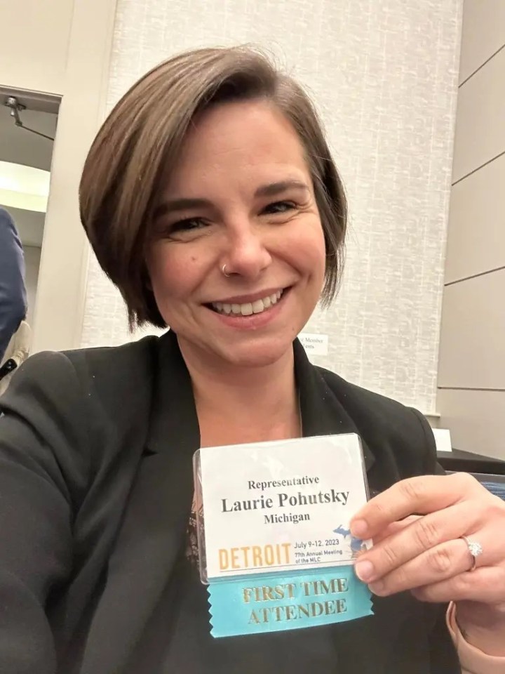 Photo of Laurie Pohutsky, Michigan representative, holding her attendee name tag.