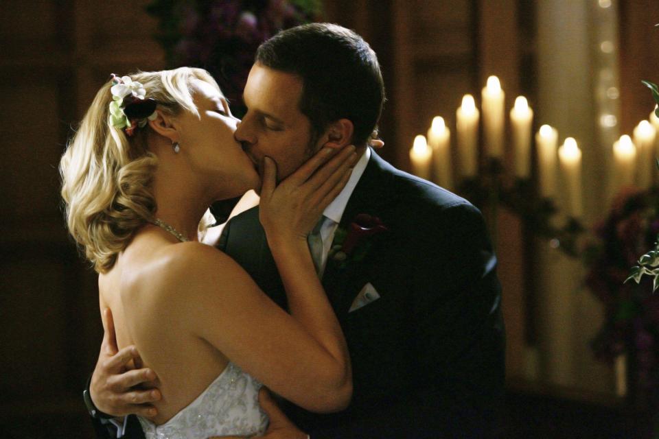 Katherine Heigl and Justin Chambers kissing at a wedding in Grey's Anatomy.