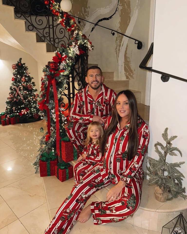 Charlotte Crosby, Jake Ankers, and their daughter in matching Christmas pajamas.