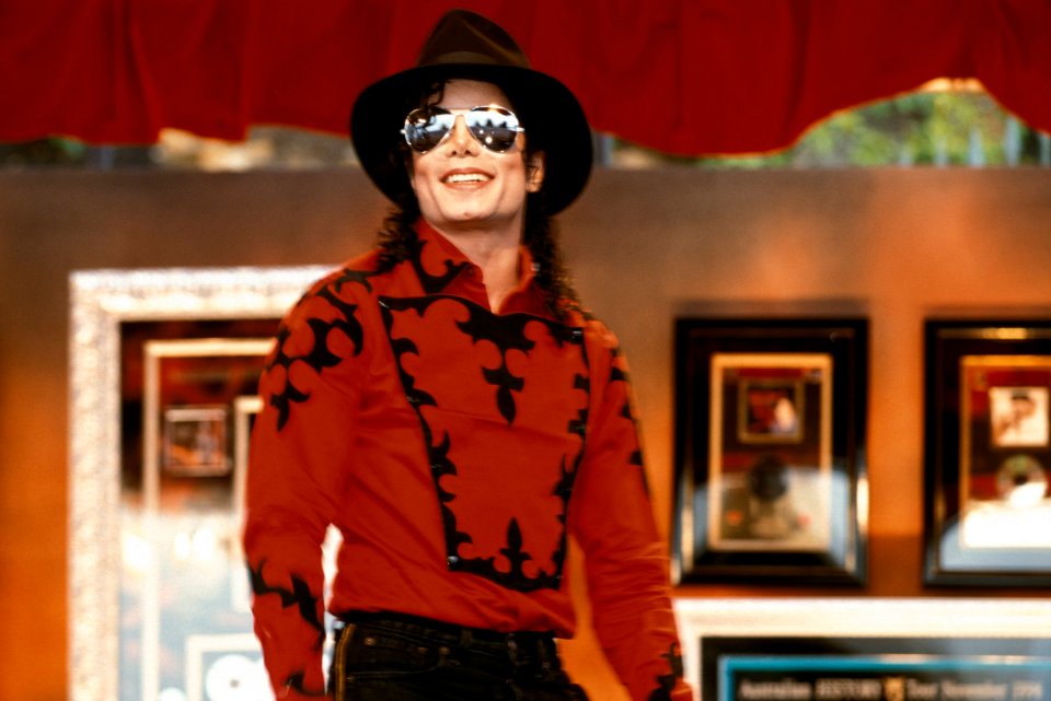 Portrait of Michael Jackson wearing a hat and sunglasses.