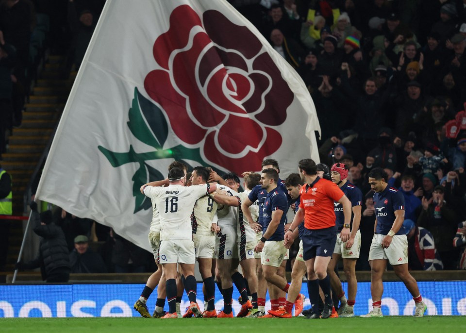 French rugby players celebrating a try.