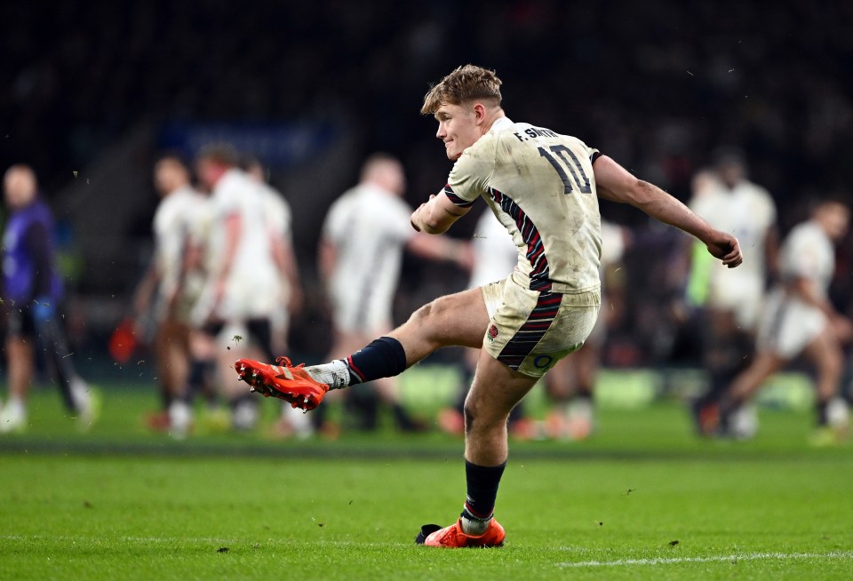 Fin Smith of England kicking a conversion during a rugby match.