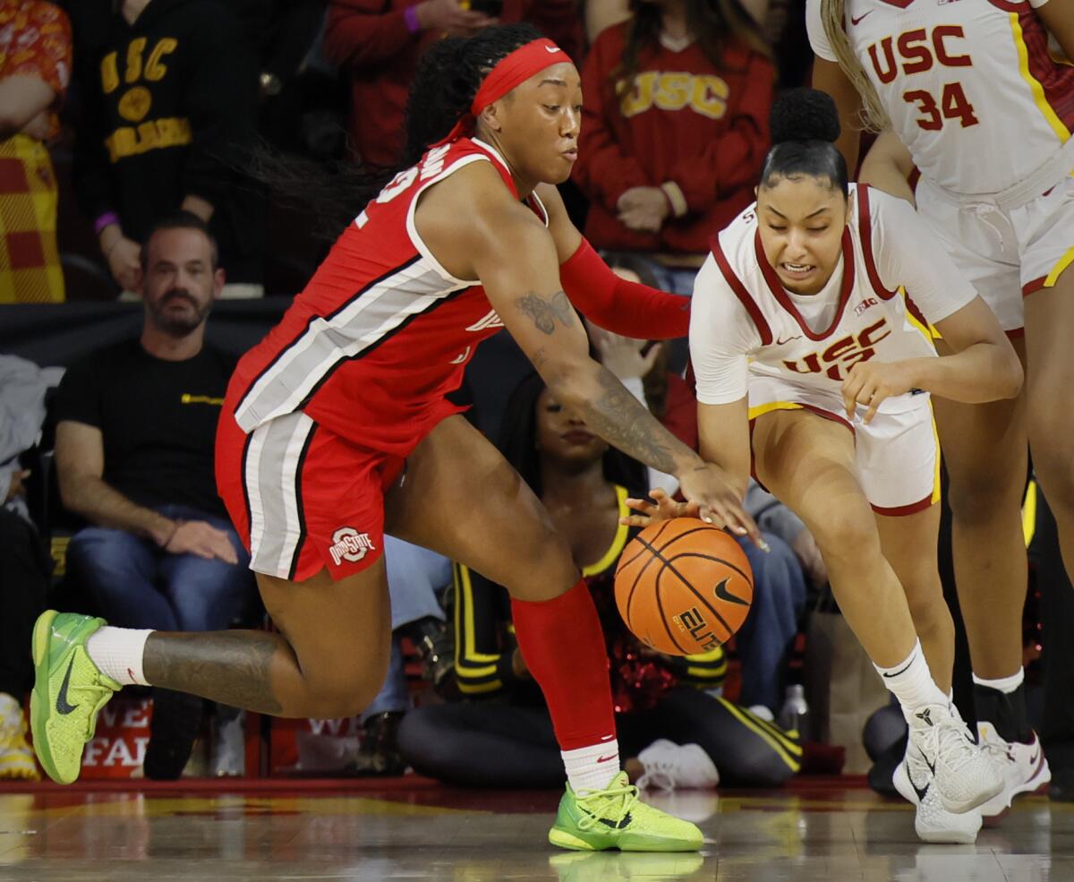 USC guard JuJu Watkins, right, takes control of a loose ball in front of Ohio State forward Cotie McMahon.