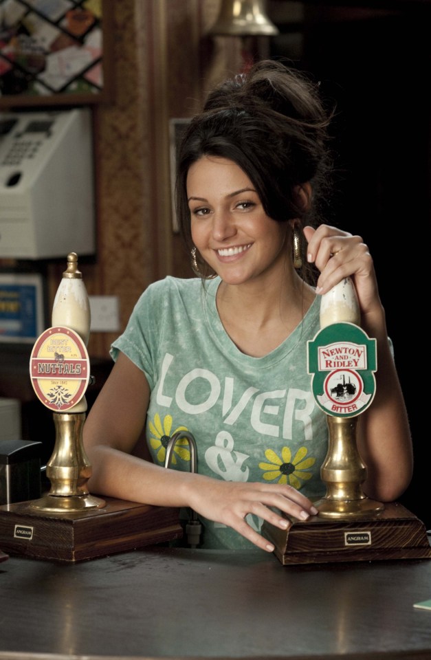 Tina McIntyre from Coronation Street behind a bar.