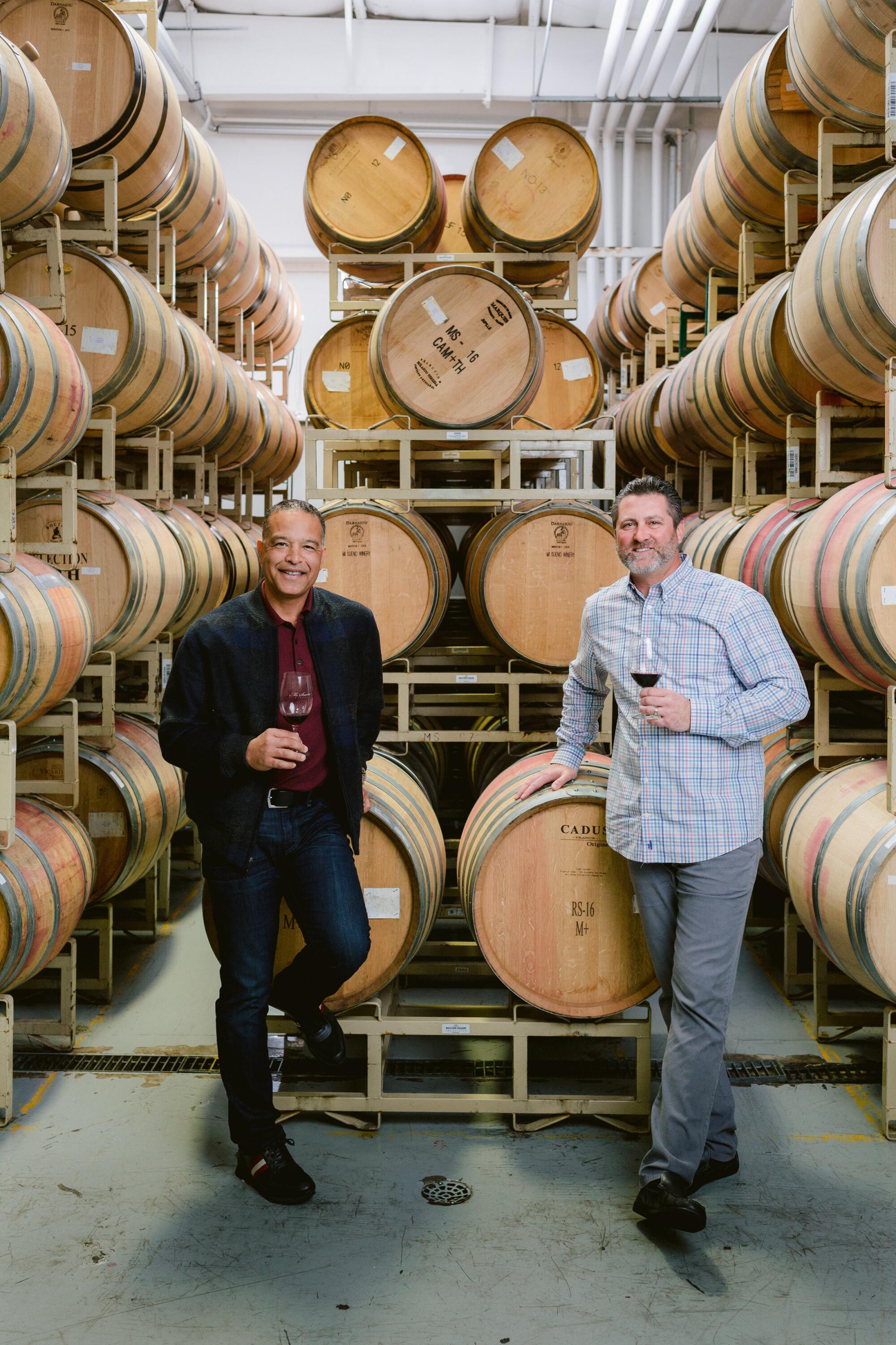 Dave Roberts and Rich Aurilia stand in the barrel room at Red Stitch Wines