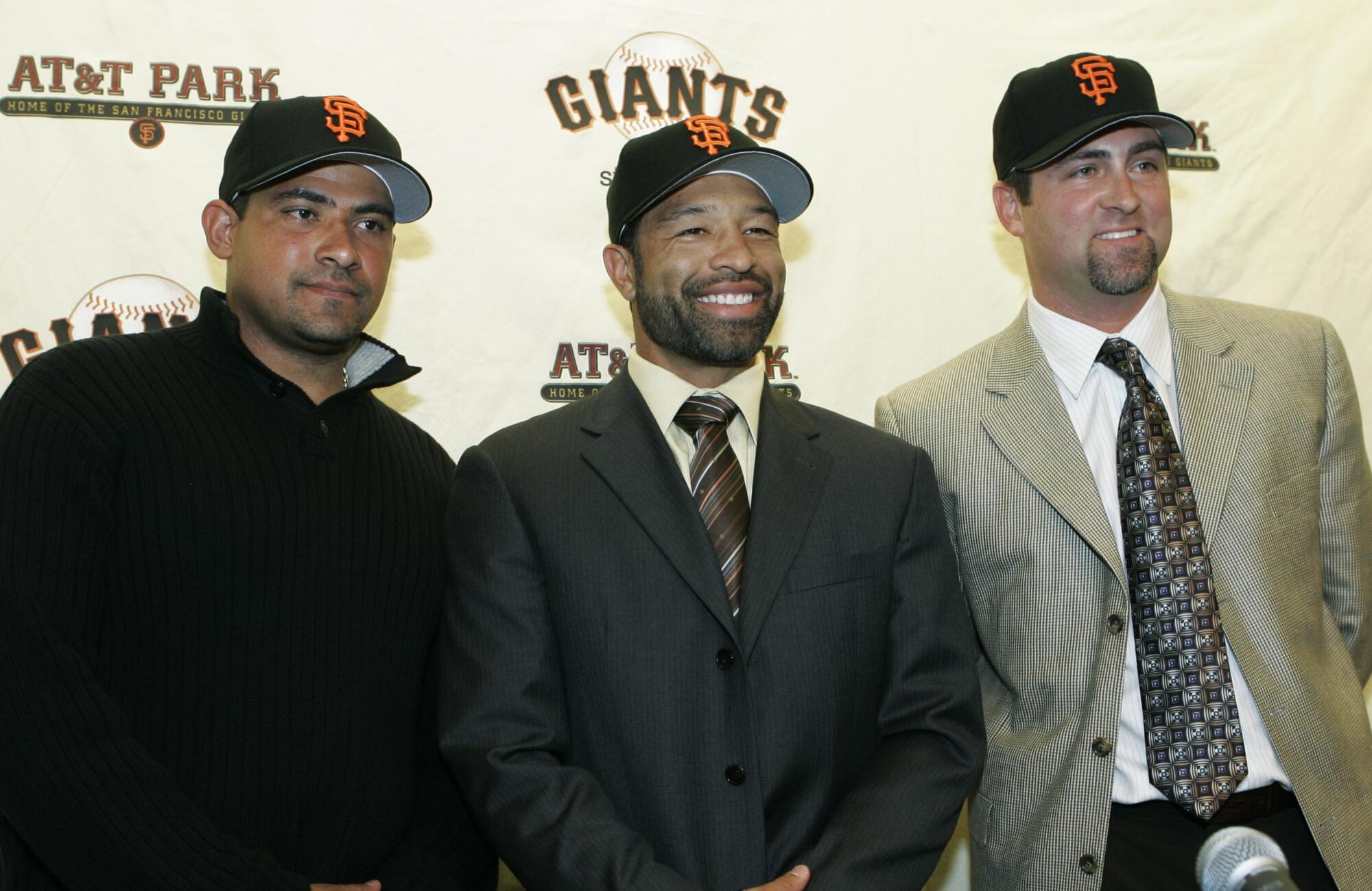 From left, Benjie Molina, Dave Roberts, and Rich Aurilia introduced during a news conference in San Francisco in Dec. 2006.