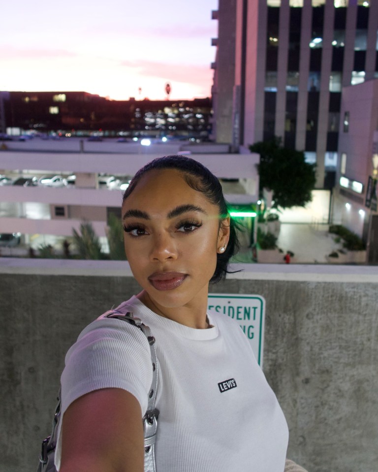 Selfie of a woman wearing a white Levi's shirt.