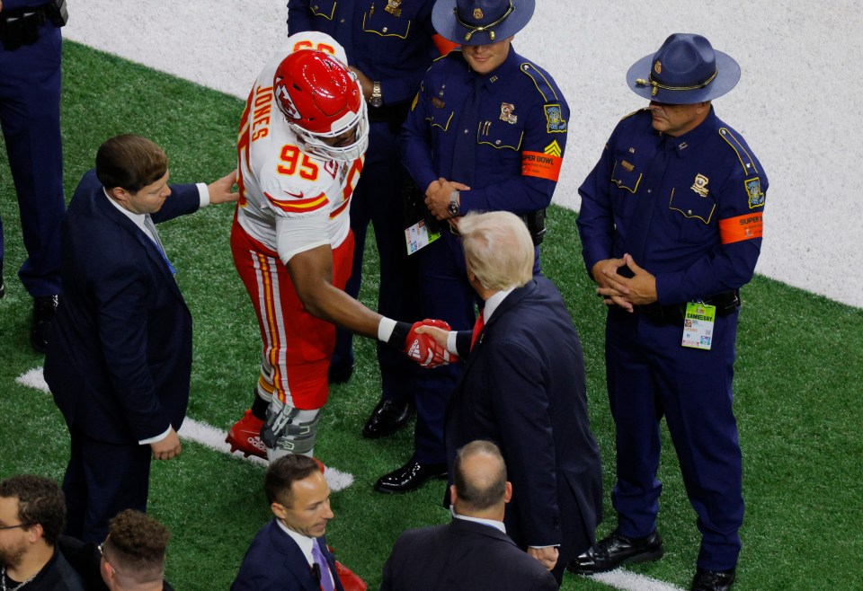 Donald Trump shaking hands with Kansas City Chiefs player Chris Jones before a Super Bowl game.