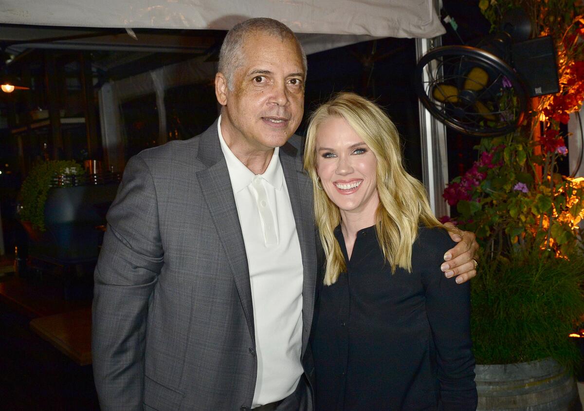 Sports agent Bill Duffy and business manager Lara Beth Seager pose for a photo at a William Morris Endeavor cocktail party.