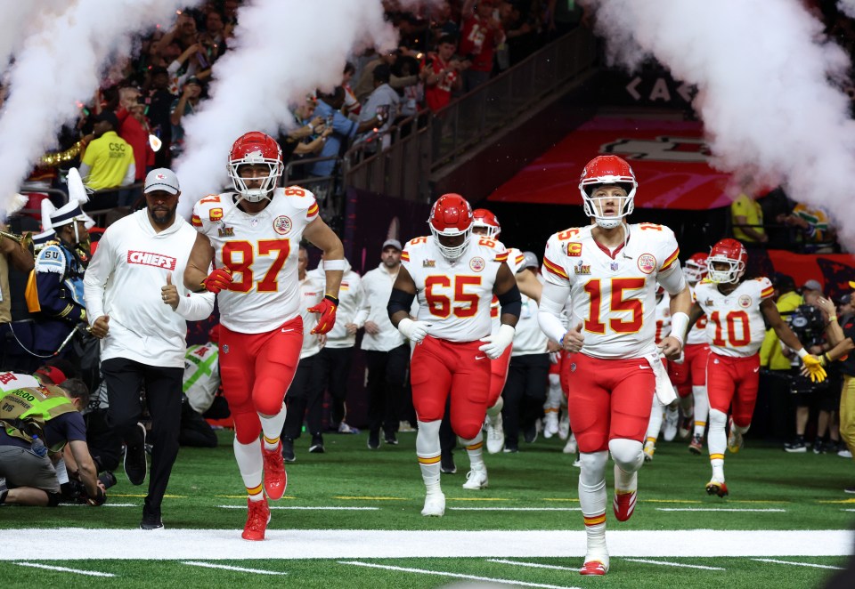 Kansas City Chiefs players running onto the field.