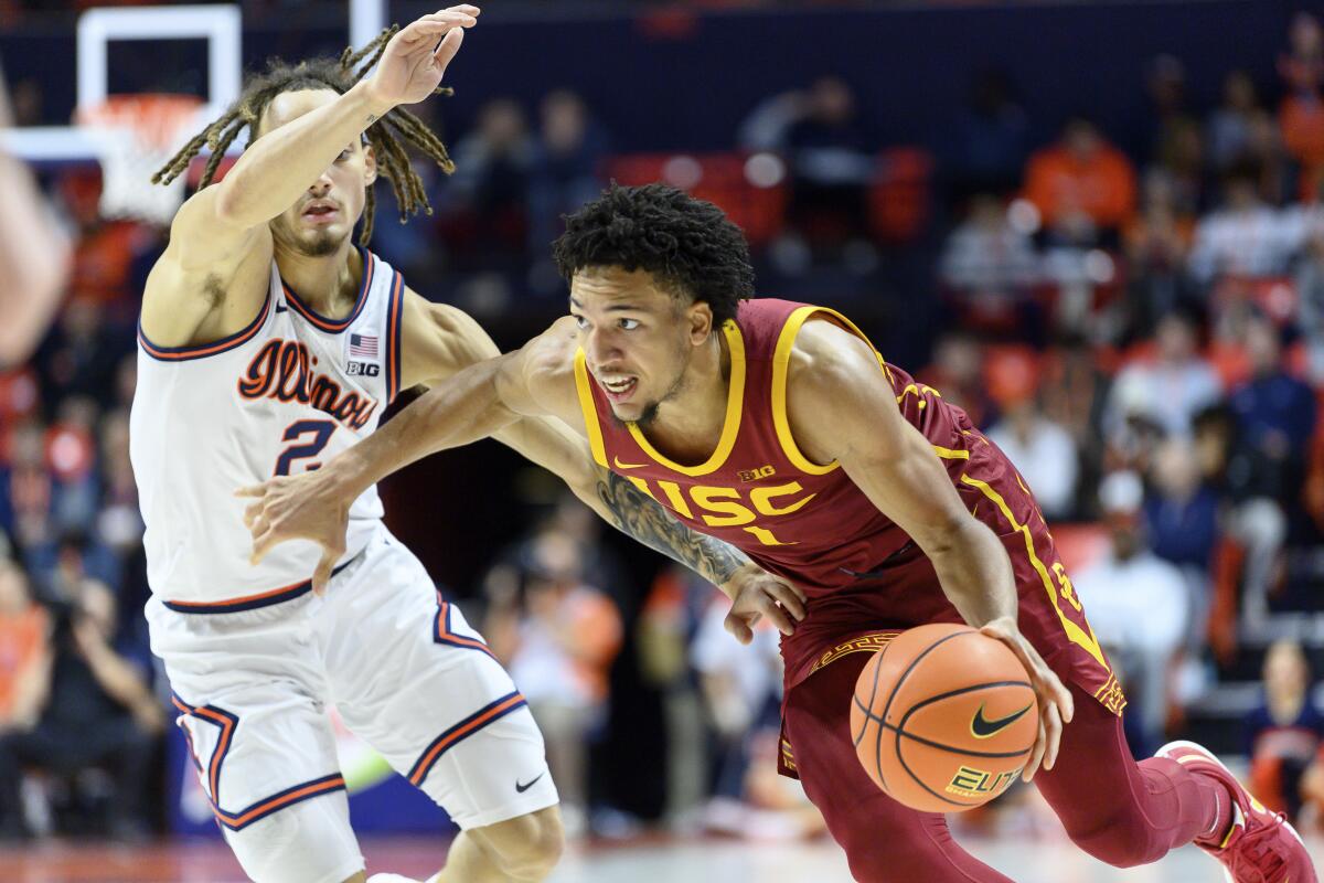 Desmond Claude drives on Illinois' Dra Gibbs-Lawhorn in a January game.