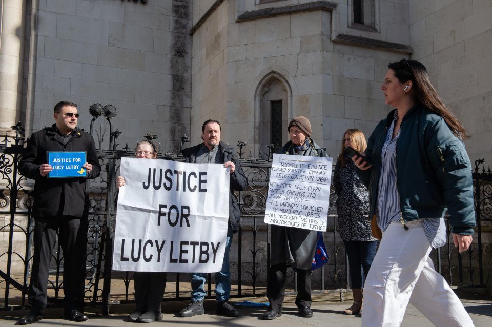 a group of people holding signs that say justice for lucy letby