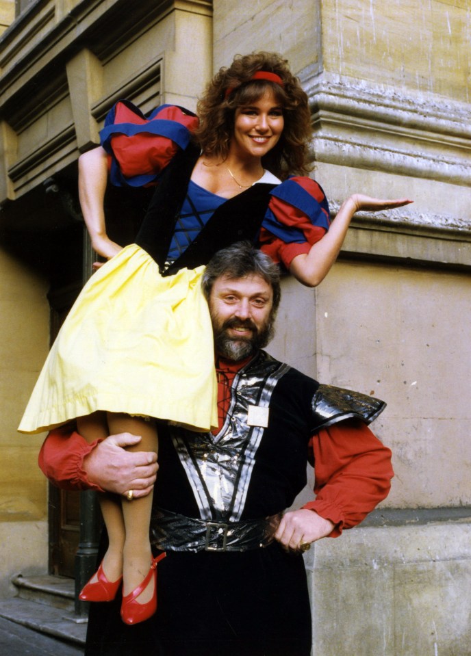 a man is carrying a woman in a snow white costume