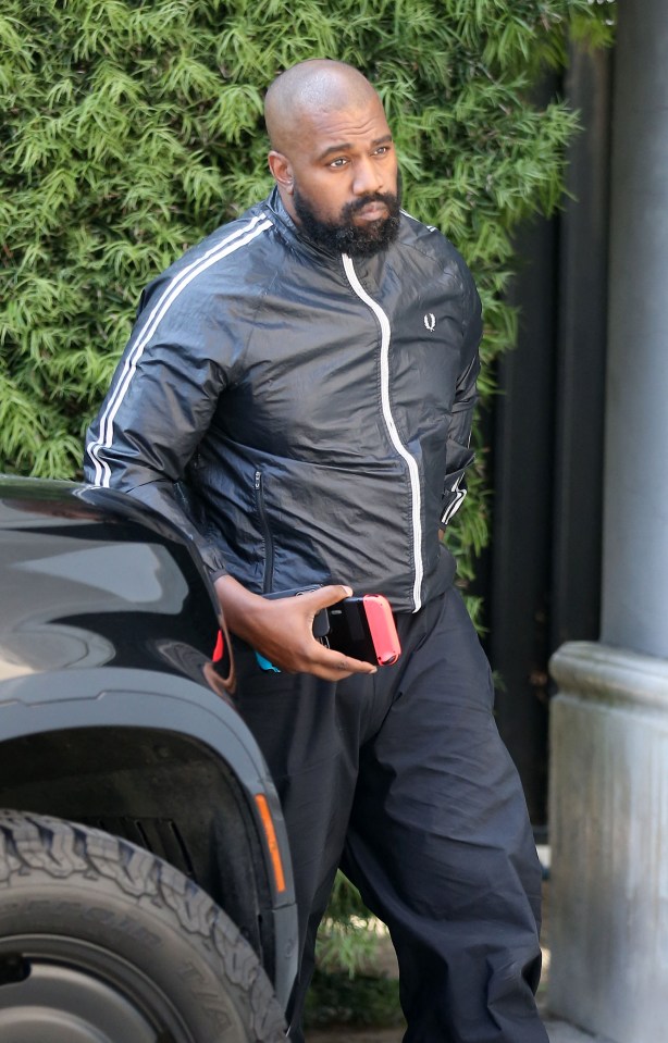 Kanye West arriving at a studio.