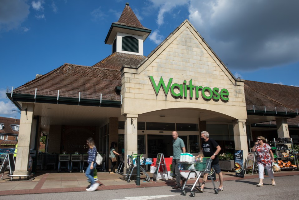 Shoppers leaving a Waitrose supermarket.