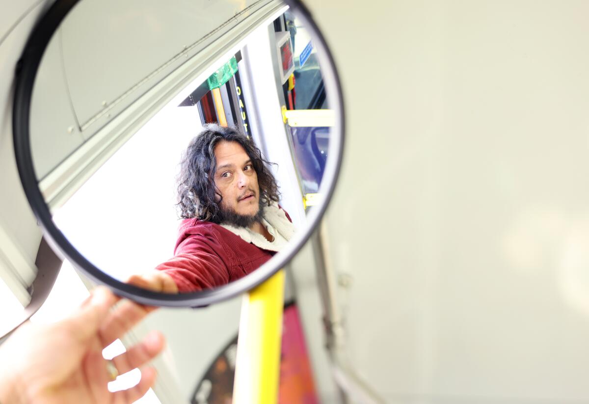 Felipe Esparza is seen in a mirror