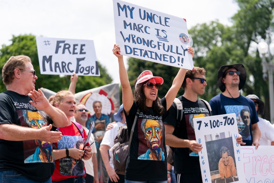 Protestors holding signs advocating for the release of Marc Fogel.