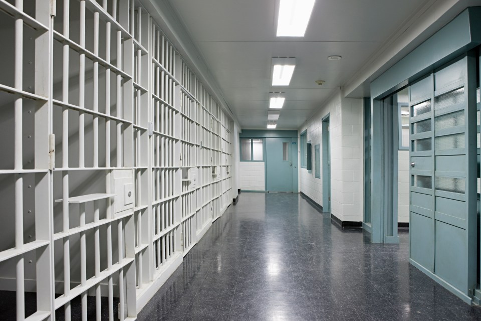 Jail hallway with prison cells.