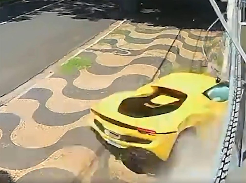 Yellow Ferrari crashing into a house.