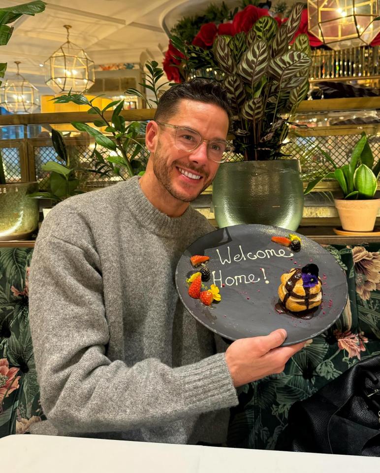 Man holding a plate with a dessert and a "Welcome Home!" message.