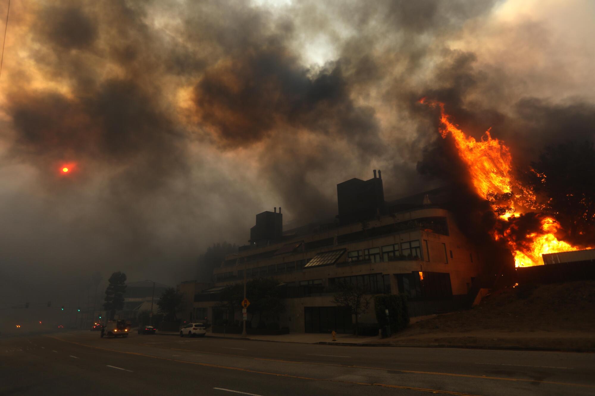 A building on Sunset Boulevard is threatened by the Palisades fire on Jan. 7. 